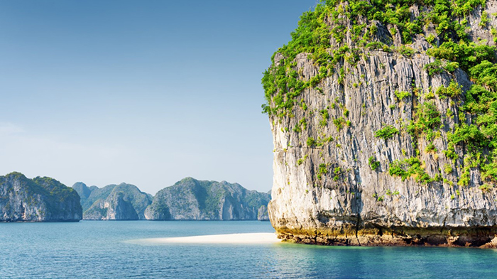 The clear sea water with white sand in Halong Bay