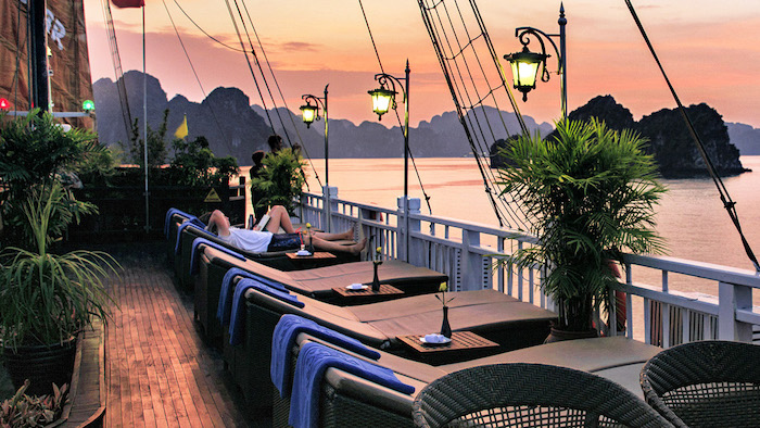 Admiring the beautiful sunset on Halong Bay cruises